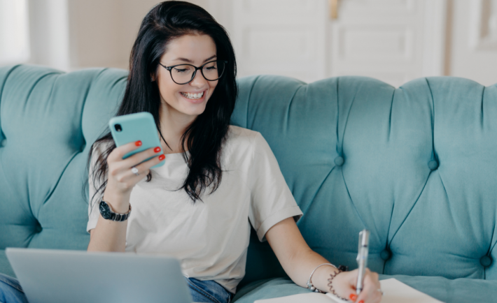 woman working from home an writing something on a notebook