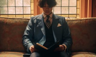 a man in a suit reading a book