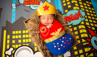 newborn baby in a wonder woman costume