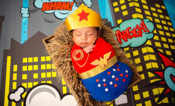 newborn baby in a wonder woman costume