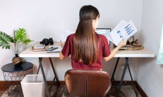 woman working from home looking at sales reports