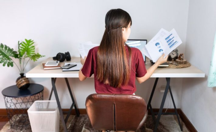 woman working from home looking at sales reports