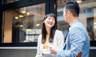 asian colleagues chatting over coffee