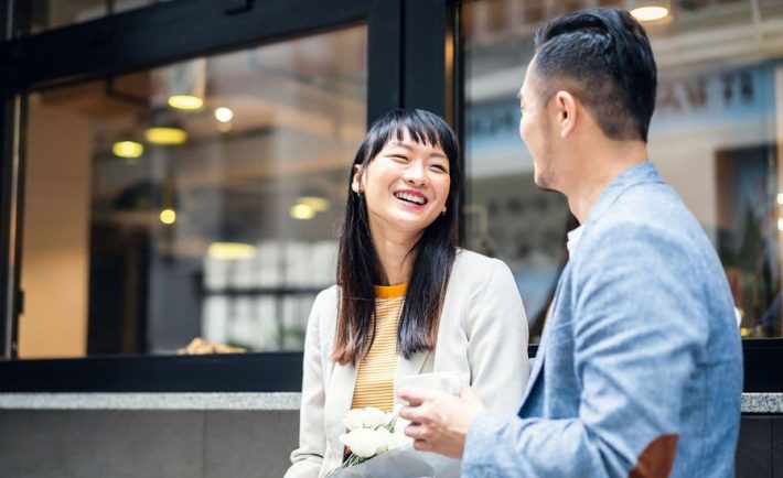 asian colleagues chatting over coffee