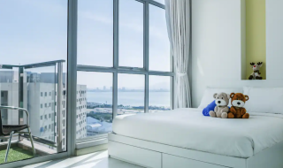 bedroom with large windows offering sea views