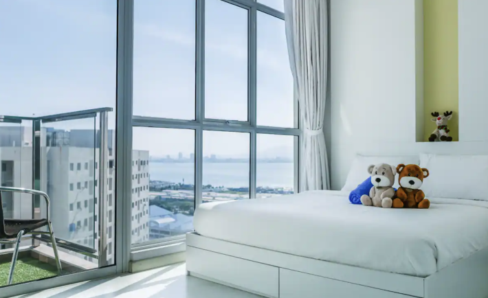 bedroom with large windows offering sea views