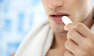 man applying lip balm