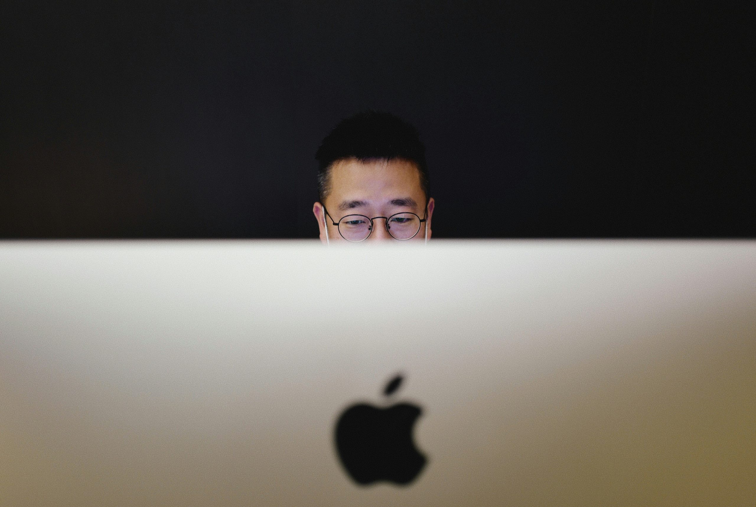 man working on his iMac