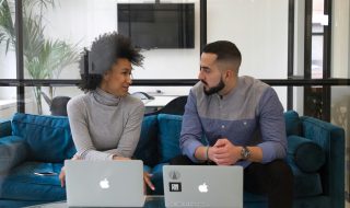 man and woman having a discussion at work