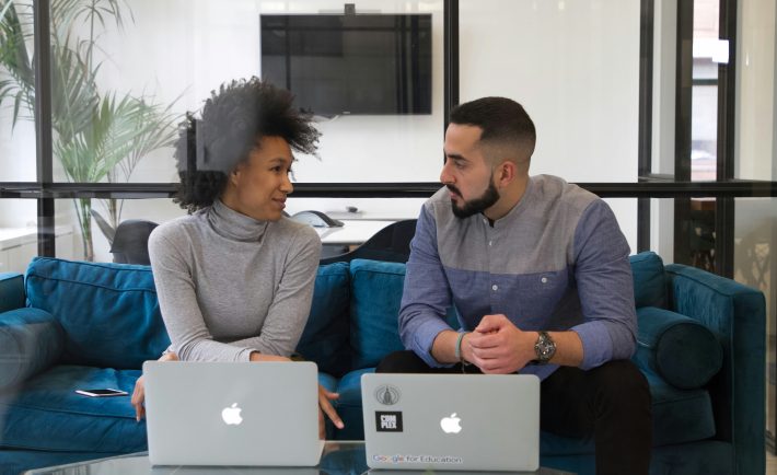 man and woman having a discussion at work