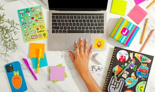 a woman's hand on a MacBook