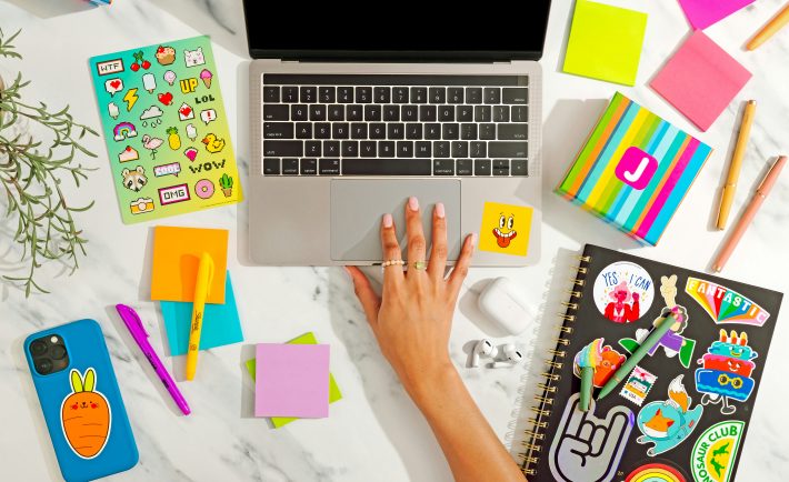 a woman's hand on a MacBook