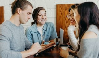 A group of people sitting around a table Description automatically generated