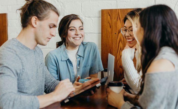 A group of people sitting around a table Description automatically generated