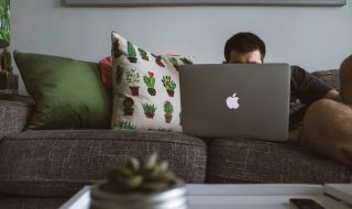 man working behind a MacBook