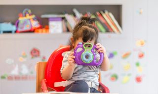 toddler with a toy camera