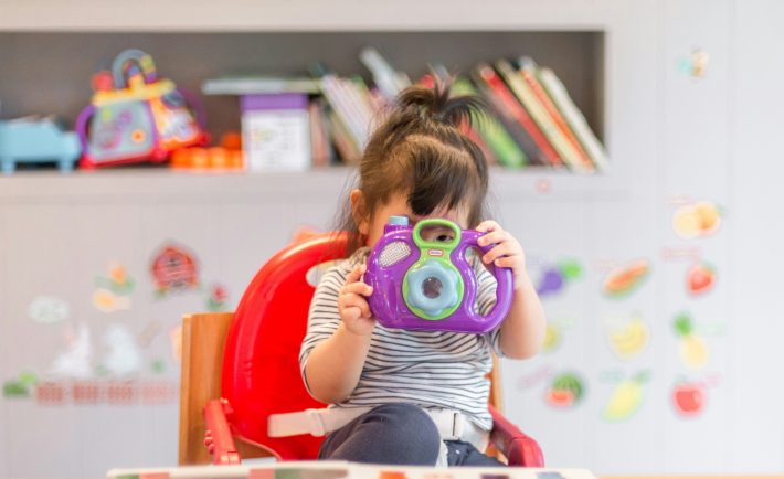 toddler with a toy camera