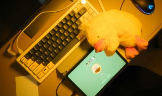 a keyboard, tablet, and a plush toy