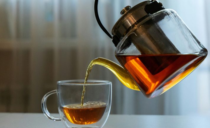 tea being poured into a glass cup