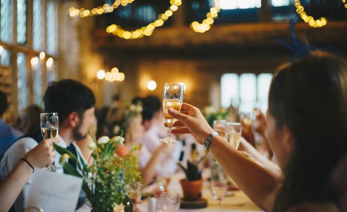 people raising wine glasses
