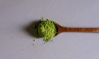 a wooden spoonful of matcha powder