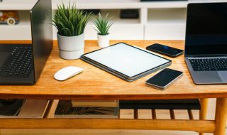 devices like laptops, tablets. and smartphones on a work desk