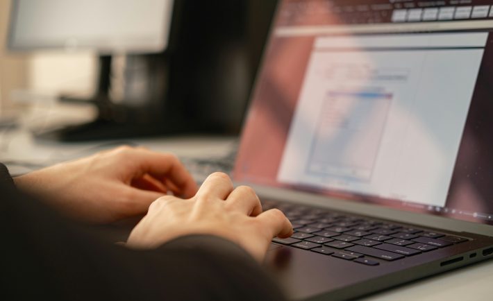 a person's hands on the laptop